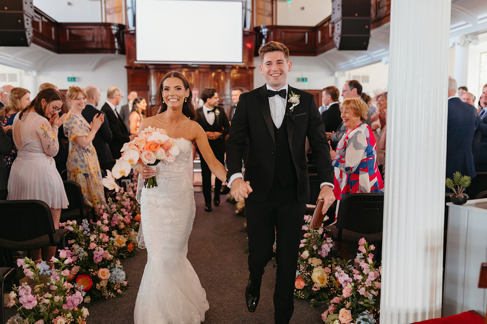 bride and groom walking out of church